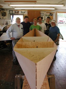 <p>Three undergraduates at the Avery Point campus learned to build Adirondack pack boats during an internship with Bill Armitage of the John Gardner Chapter of the Traditional Small Craft Association.  Shown here are (L to R) Stephen Jones, English professor at Avery Point and boating enthusiast; Bill Armitage of the TSCA, undergraduates Elizabeth Provenzano, Peter Omdahl, and Jon Turban; and Sandy E'Esposo of the TSCA. Photo by Christine Buckley</p>