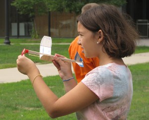 <p>This student proved adept at sending her plane to heights greater than the buildings that surrounded the 'runway' between the chemistry and pharmacy buildings. Photo by Sheila Foran</p>