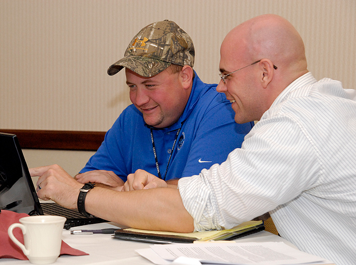 <p>UConn's Jeff Bache, right, helps out veteran Joe Cambell with his entrepreneurial endeavors at the Entrepreneurial Bootcamp for Vets on September 20. Photo by Lauren Cunningham</p>