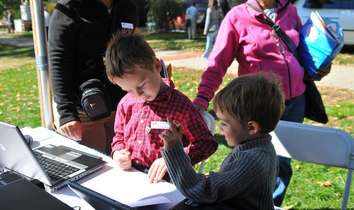<p>Maxtin and Kale Hart write letters to soldiers overseas as part of the Military Kids program at Cornucopia 2010. Photo by Jessica Tommaselli</p>