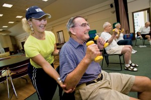 <p>Mary Carroll Root helps participants during an exercise class at the Avon Senior Center.</p>