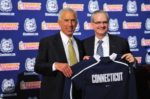 <p>Paul Pasqualoni, left and Jeffrey Hathaway, director of athletics, hold a jersey at the end of a press conference held at the Burton Family Football Complex to announce Pasqualoni's appointment as the head football coach. Photo by Peter Morenus   </p>