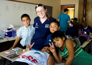 UConn dental student Jenn Merry treating children in Curarrehue, Chile.