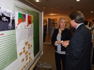 M.P.H. student Cheryl Marenick discusses her poster presentation, about disparities relative to elderly patient falls, with Richard Fortinsky in the Keller Lobby. (Chris DeFrancesco/UConn Health Center Photo)