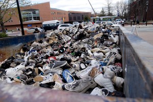 <p>Members of the UConn community made donations to Mt. Sneaker 2011 on the patio of Gampel Pavillion. At the conclusion of each spring semester, the sneakers are donated  to the Nike Reuse-A-Shoe Program to be converted to new surfaces such as running tracks and playgrounds.Photo by Lauren Cunningham</p>