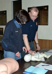 Tony Ruggerio showing Cathy Walter how to do CPR on an infant. (Laura Phillips Ward for UConn Health Center)