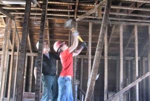 <p>Under the watchful eye of Andy Derr, Habitat for Humanity construction manager, Lauren Young, from Storrs, wields a mighty sledgehammer.  </p>