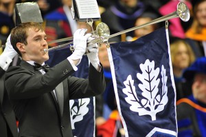 <p>Herald trumpeters of the University Wind Ensemble play during the entrance procession of the graduate commencement ceremony held at Gampel Pavilion. Photo by Peter Morenus</p>
