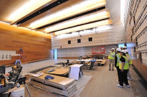 <p>John Warner of architectural and engineering services points out details of the 200 seat lecture hall in the West Classroom Building, now under construction. </p>