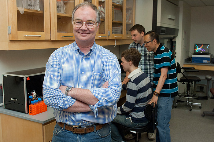 Professor Michael Lynes in his lab with, graduate students from left, Ryan Molony, Jamie Rice, and postdoctoral research associate Jongseol Yuk.