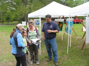 Mark Rudnicki, right, helps a family learn how to use a light meter as he explains how to conduct the experiment at Chatfield Hollow State Park in Killingworth. Photo courtesy of Mark Rudnicki