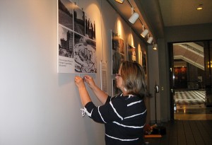 Irene Peterson with Biomedical Media Communication works on the 50th anniversary wall display at the LOB.