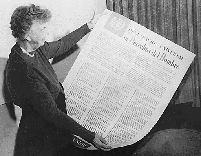 Eleanor Roosevelt looks over the Universal Declaration of Human Rights in Spanish.