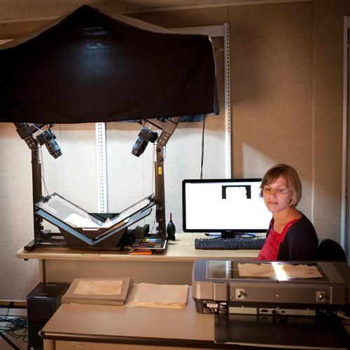 Digital media technician Rita Lombardi works with the fragile documents.