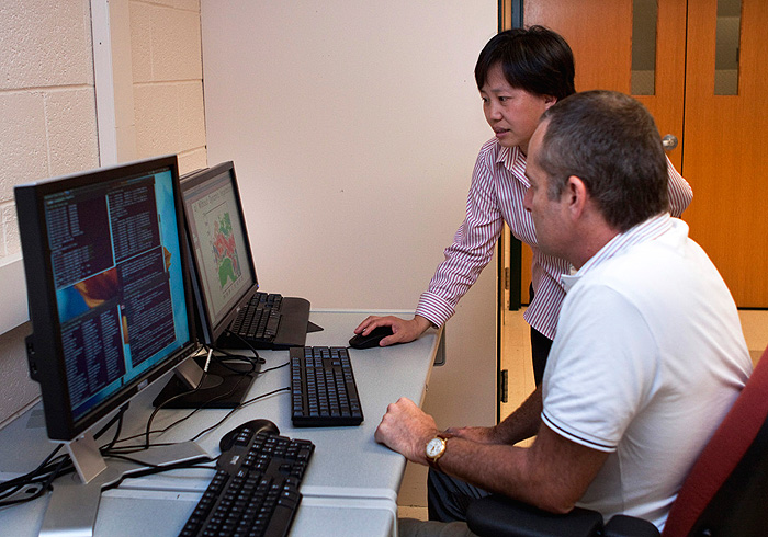 Guiling Wang, director of the environmental engineering program, and Jeremy S. Pal of Loyola Marymount University, work in the lab.