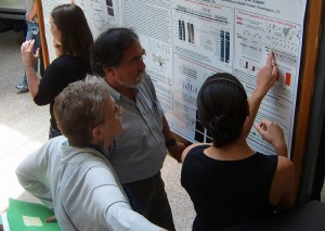Graduate school faculty Dr. Carol Pilbeam and Leonardo Aguila talk with doctorate in biomedical science student Mathilde Bonnemaison about her research.