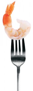 Photo of a fork holding a shrimp.