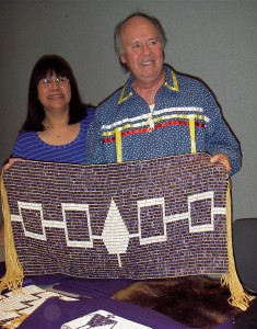 Christine Abrams, left, chair of the Haudenosaunee Standing Committee on Burial Rules and Regulations, and Peter Jemison, faithkeeper for the Seneca Nation, hold a reproduction of the Haudenosaunee Hiawatha Belt.