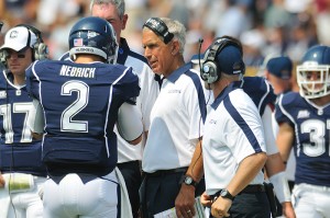 Head Coach Paul Pasqualoni speaks with players on the sidelines during the football game against Fordham at Rentschler Field on September 3, 2011.