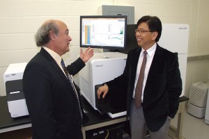 Dr. Marc Lalande, professor and chairman of the Department of Genetics and Developmental Biology, talks with Dr. Edward Liu, Jackson Lab president and CEO. (Tina Encarnacion/UConn Health Center Photo)