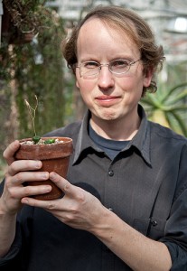 Botanist Matt Opel in the EEB greenhouse with the new species Tylecodon opelli. (Max Sinton '15 (CLAS)/UConn Photo)