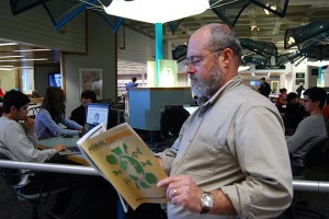 Animal science professor Steve Zinn looks over an issue of the open access journal Animal Frontiers in Babbidge Library. Zinn is editor-in-chief of the journal. Open access is the focus of a week-long celebration at the University Libraries Oct. 24-30. (Suzanne Zack/UConn Photo)