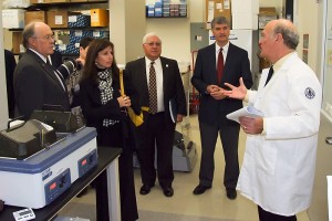 Marc Lalande, far right, senior associate dean for research and planning, talks with legislators during a lab tour of the Cell and Genome Sciences building. (Tina Encarnacion/UConn Health Center Photo)