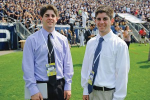 Twins Matthew McDonough '12 (CLAS), left, and Colin McDonough '12 (CLAS) covering a football game at Rentschler Field in East Hartford. (Peter Morenus/UConn Photo)