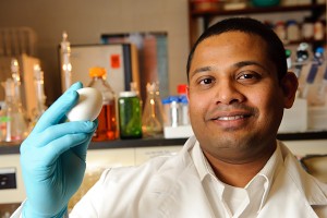 Anup Kollanoor Johny with an egg at his lab in the White Building. (Peter Morenus/UConn Photo)