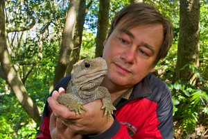 Piotr Naskrecki displays a tuatara, a species of reptile that roamed the earth at the same time as the dinosaurs. 