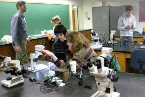 The program concluded with a laboratory segment in the Torrey Life Sciences Building. Gus Larsen Giangrave and Cindy Larsen of Scotland, Conn., center, use a stereoscope to view different microscopic species collected from Swan Lake.