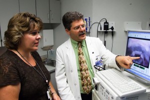Speech pathologist Janet Rovalino and Dr. Denis Lafreniere of the Health Center's Voice and Speech Clinic review a video image of a patient's vocal cords. (Chris DeFrancesco/UConn Health Center Photo)