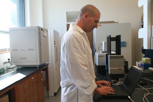 Dr. Kyle Hadden analyzes assay data with the microplate reader on November 17, 2011. (/UConn Photo)