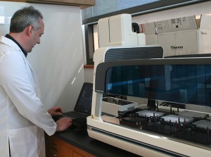 Dr. Dennis Wright prepares the liquid handler for an automated assay on November 17, 2011. (/UConn Photo)