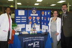 Fourth-year medical students Cynthia Emilie Armand (left), Irina Lister, and Dr. Bruce Gould at the 10th District Senior Fair in New Haven on November 30, 2011. (provided by Irina Lisker for UConn Health Center)