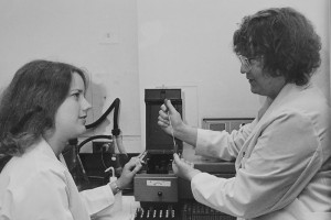 Dr. Jane Chapitis (right) was one of three women in the first medical and dental graduating class in 1972. She then became a member of the School of Medicine faculty. Here she teaches Susanne Harrison, a summer volunteer, how to use an ultraviolet-visible spectrophotometer, used for analyzing protein.(UConn Health Center Archive)