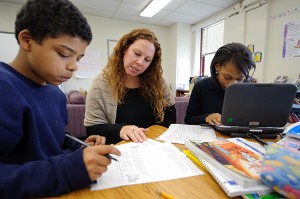 Sixth-graders work on writing projects with teacher Kim Albro '99 (ED), '00 MA. (Peter Morenus/UConn Photo)