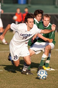 Colin Bradley '14 (Clas) beats two defenders to the ball.