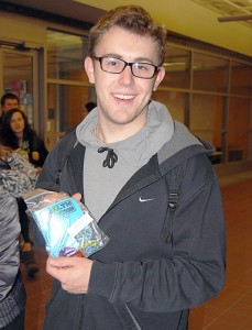 Andrew Verbeke, a junior political science major, shows off his stress relief packet distributed by the Health Education Office and the UConn Libraries on Monday in Homer Babbidge Library.(Suzanne Zack/UConn Photo)
