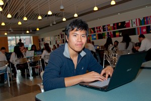 Pei-Kang Wu works on his laptop in the School of Business Café. (Ariel Dowski '14 (CLAS)/UConn Photo)