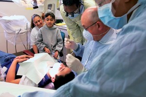 Richard Skinner, D.M.D., Pediatric Dentistry, provides care to a patient at the Burgdorf Community Health Clinic. (Al Ferreira for UConn Health Center)