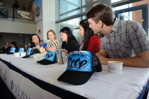 Senior Scoop hats sit on the table as the judges engage in final deliberations. (Peter Morenus/UConn Photo)