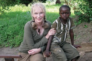 Actor and humanitarian Mia Farrow sits with a young Darfuri survivor of violence, 2007