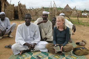 Actor and humanitarian Mia Farrow sits with Darfuri men at the Gouroukoum Camp, 2007