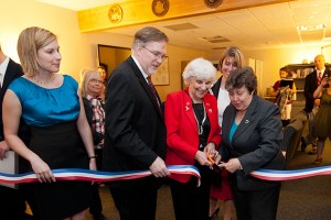 Caitlin Davies, left, '12 (CANR), John Saddlemire, vice president for student affairs, Gloria Hutchinson, federation of Women's Clubs of Connecticut, and Linda Schwartz, commissioner of the department of veterans' affairs, cut the ribbon to open the Student Veterans Oasis at the Student Union on March 21, 2012. (Peter Morenus/UConn Photo)