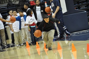 Hartford students from three elementary and middle schools who took part in the Read & Raise Initiative play basketball in Gampel Pavilion. (Shawn Kornegay/UConn Photo)