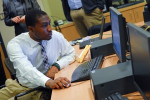 Cigna intern Justin Green '13 (ENG) works in the Cigna Innovation Lab in room 360 of the ITE Building. (Ariel Dowski '14 (CLAS)/UConn Photo)