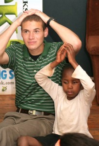 Aaron Hayes '12 (CLAS), with a young burn victim in South Africa.