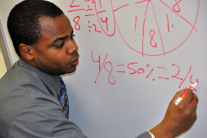 Aaron Clark demonstrates math terms in his classroom. (Shawn Kornegay/UConn photo)