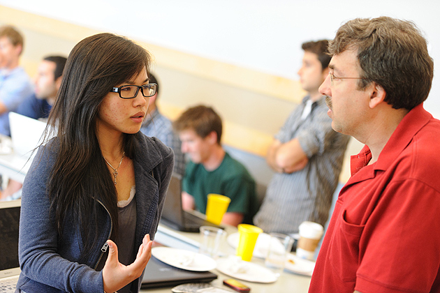 Jolina Li '12 (BUS), left, speaks with UConn's Eric Knight, inQbator coordinator and one of this year’s Innovation Quest judges. (Peter Morenus/UConn Photo)